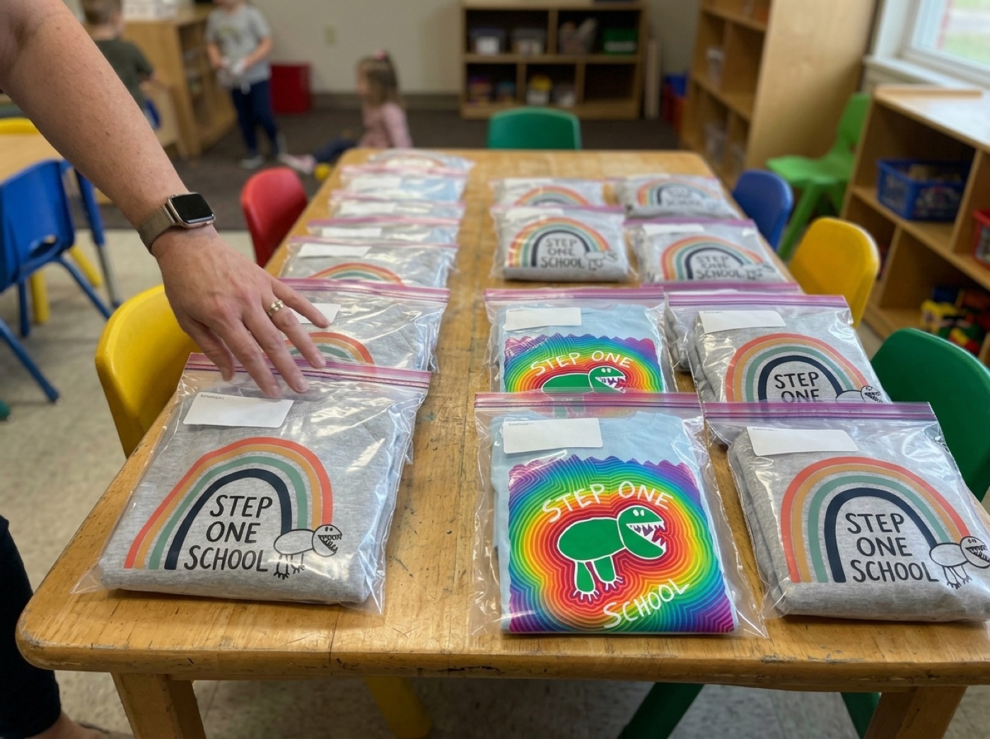 Step One shirts bagged and labeled on a classroom table